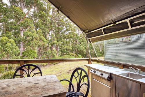 an outdoor kitchen with a sink and a table and chairs at NRMA Port Arthur Holiday Park in Port Arthur
