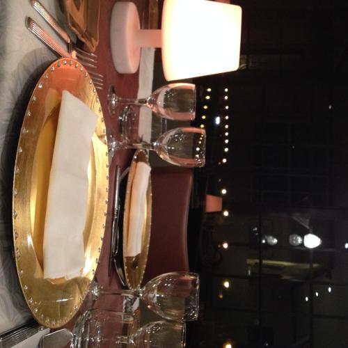 a gold mirror on a wall with a sink at Hôtel Restaurant du Lac in Combourg