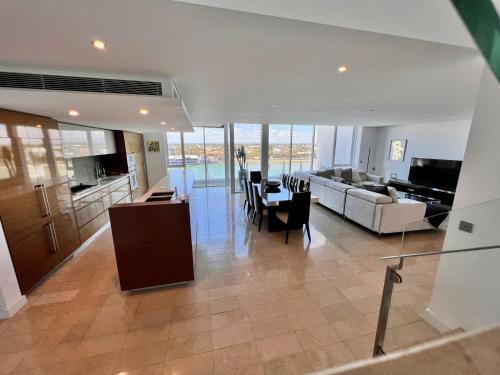 a living room with a couch and a table and chairs at Bayview 705 in Mandurah