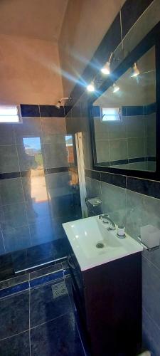 a bathroom with a sink and a mirror at posada de la luna in Belén
