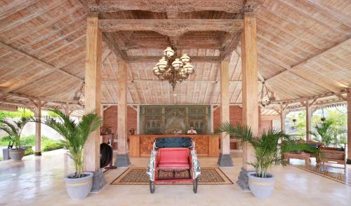 a large lobby with a chandelier and a red chair at Vivara Bali Private Pool Villas & Spa Retreat in Jimbaran