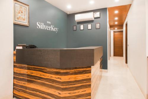 a hotel lobby with a reception desk with wood at SilverKey M&m Residency in New Delhi