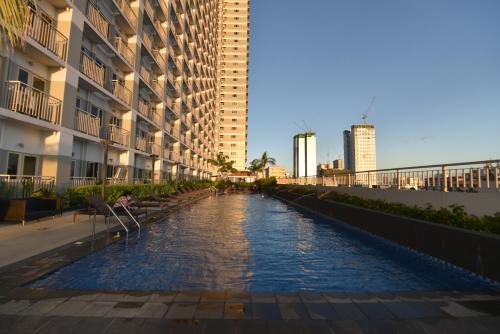 a canal in the middle of a city with buildings at Condo in Pasay in Manila