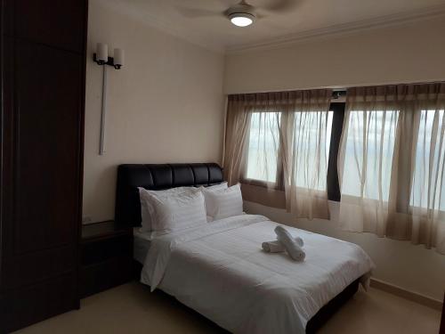 a bedroom with a bed with a stuffed animal on it at Batu Ferringhi Luxury Seaview Suite - 3Br in Batu Ferringhi