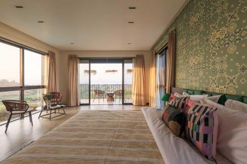 ein Wohnzimmer mit einem Sofa und Meerblick in der Unterkunft StayVista at La Mer - Igatpuri in Nashik