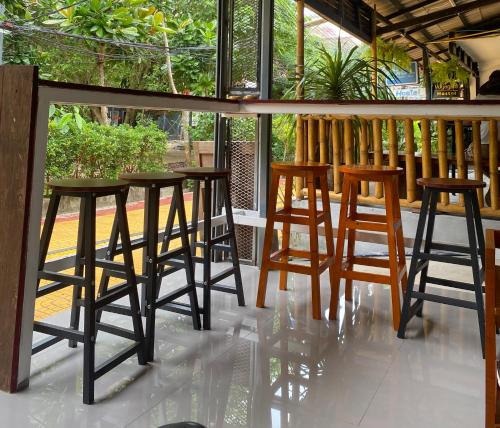 a group of stools sitting on a porch at Magic Hostel in Phi Phi Don