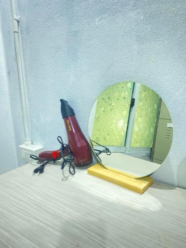 a mirror and a pair of scissors on a bed at Magic Hostel in Phi Phi Don