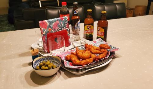 a table with a tray of food and bottles of beer at La Bohème in La Paix