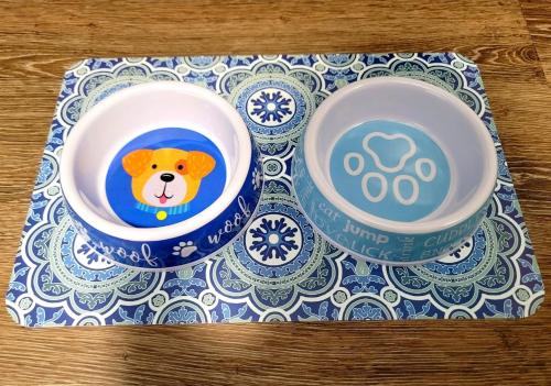 two bowls with a dog in them on a table at Searenity, Waterside studio in the heart of Treasure Island, walk to beach in St Pete Beach