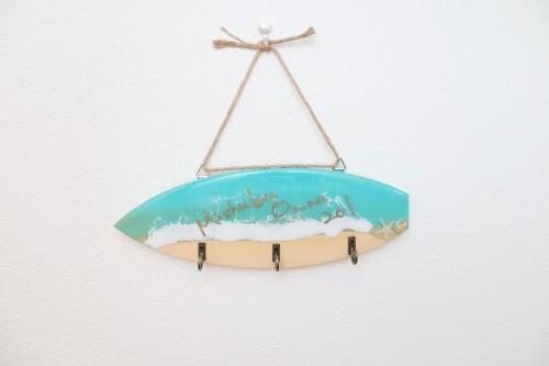 a surfboard hanging on a wall at MishukuOnna201 in Onna