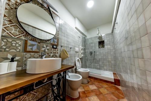 a bathroom with two toilets and a mirror at Sebeto Duomo in Naples