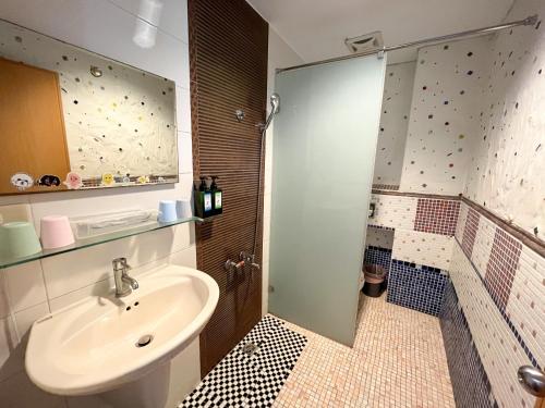 a bathroom with a sink and a shower at Tz Shin Resort Hostel in Kenting