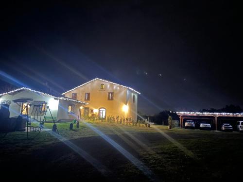 a house with lights on the side of it at night at L'Acero di STALL in Viterbo