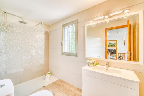 a bathroom with a white sink and a mirror at Ideal Property Mallorca - Sirenas in Playa de Muro