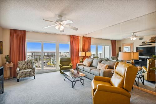 a living room with a couch and chairs and a tv at SeaCrest 706 condo in Fort Walton Beach