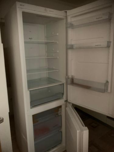 an empty refrigerator with its door open in a room at Tibra Residence in Sarajevo
