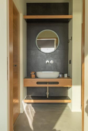a bathroom with a sink and a mirror at EGO Villas Lefkada in Évyiros
