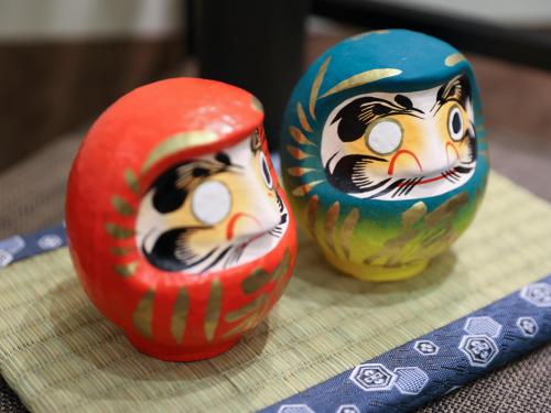 two vases with cats painted on them sitting on a table at Dormy Inn Takasaki in Takasaki