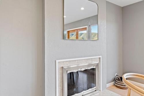 a fireplace in a living room with a mirror at @ Marbella Lane - Hidden Gem in Pacifica! in Pacifica