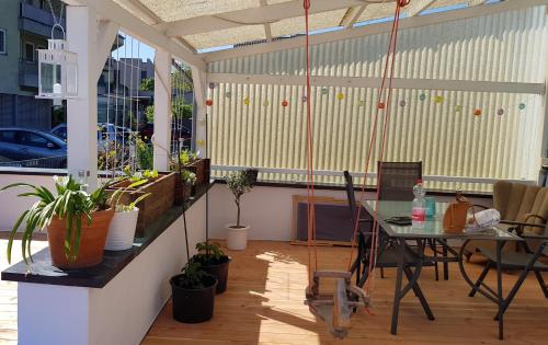 a patio with a table and potted plants at Fewo Am Tiefen Weg in Karlstadt