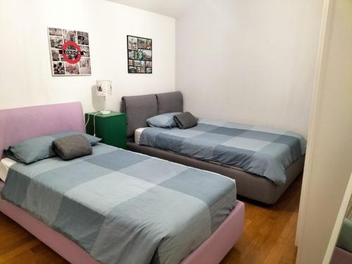 a room with two beds and a chair in it at Adria Beach Apartment in Cavallino-Treporti