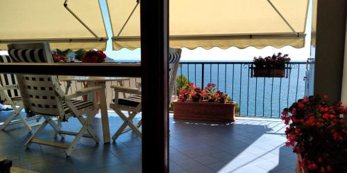 a view from the balcony of a house with a table and chairs at Capo Cervo - Rocce di Capo Mimosa in Cervo