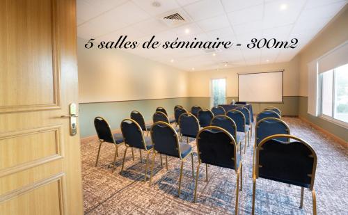 a conference room with chairs and a podium at Hôtel Mount Venturi - Aix-En-Provence Sainte-Victoire - Bar & Restaurant & Padel in Rousset