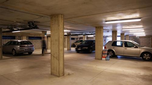a parking lot with cars parked in a parking garage at Garden Hotel in Arezzo
