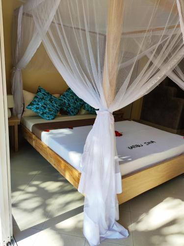 a bedroom with two bunk beds with curtains at Princess of Zanzibar in Michamvi
