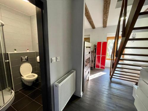 a bathroom with a toilet and a staircase at Das Hostel Rijeka in Rijeka