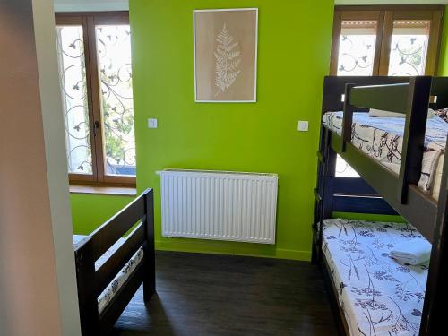 a room with two bunk beds and green walls at Das Hostel Rijeka in Rijeka