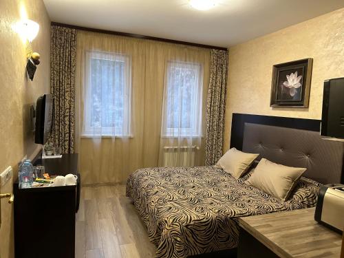a hotel room with a bed and a window at Apartments & Rooms Royal Plaza in Borovets