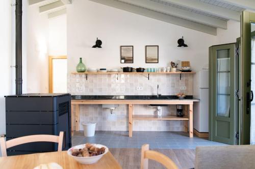 a kitchen with a wooden table and a counter at Casa Rural Monte Zarro in Cudillero