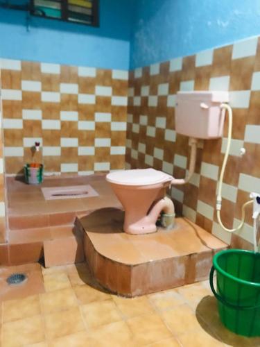 a bathroom with a toilet in a room at Royal Rasool Residency in Paramagudi