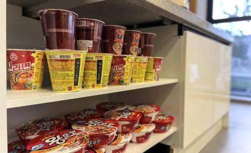a shelf filled with lots of canned food at Brown Dot Hotel Yangsan Seochang in Yangsan