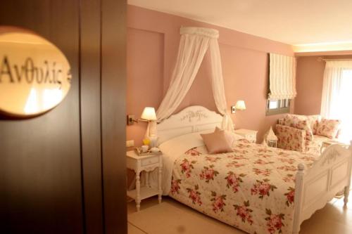 Aerinon Guesthouse في نافبليو: غرفة نوم مع سرير أبيض وطاولة مع منضدة