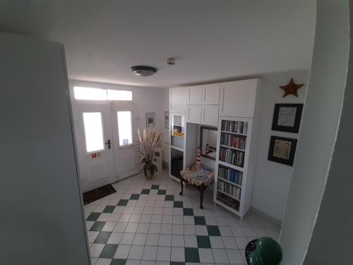 a hallway with a room with a table and a floor at Villa Bella Vista - Meerblick 2 in Sassnitz