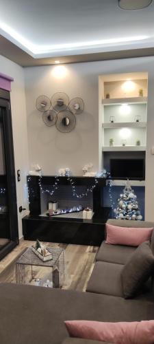 a living room with a couch and a christmas tree at Paraiso Azul Villas in Áyios Dhimítrios