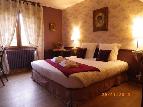 a bedroom with a bed with towels on it at Chambres et Table d'Hôtes Les Machetières in Langeais