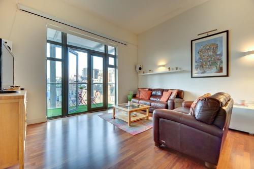 a living room with a couch and a table at Crown Apartments 3B Ideal Choice for City Breaks in Newcastle upon Tyne