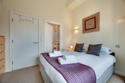 a bedroom with two beds with towels on them at Crown Apartments 309 by Week2Week in Newcastle upon Tyne