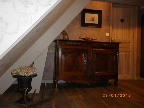 a stairway with a wooden cabinet and a stair railing at Chambres et Table d'Hôtes Les Machetières in Langeais