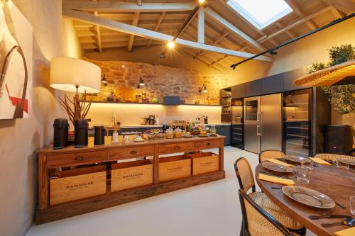 a large kitchen with a table and chairs at THE PINTA Boutique in Armamar
