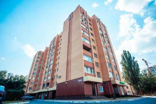 a tall red brick building on a street at Molex Apartments in Chernihiv