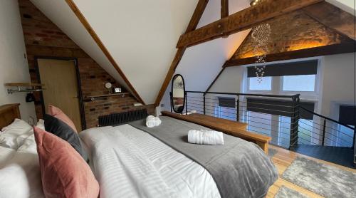 a bedroom with a large bed and a balcony at Chapel row 1 in Wirksworth