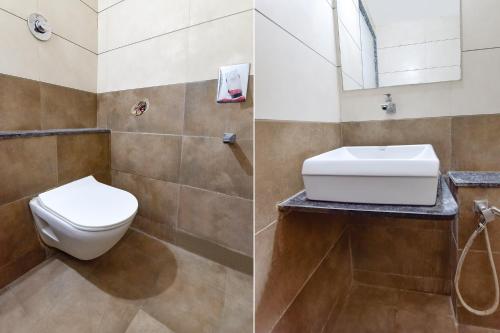 a bathroom with a toilet and a sink at FabHotel Crystal - Nr Odau Ring Road in Ahmedabad