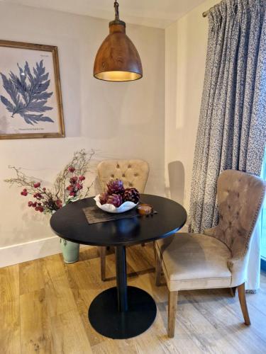 a dining room with a table and two chairs at West Highland Hotel in Mallaig