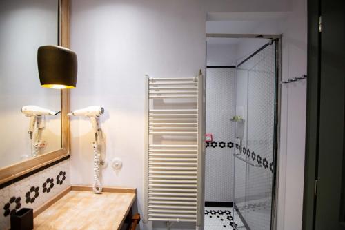 W łazience znajduje się prysznic, umywalka i lustro. w obiekcie Vila Ebel w mieście Korcza