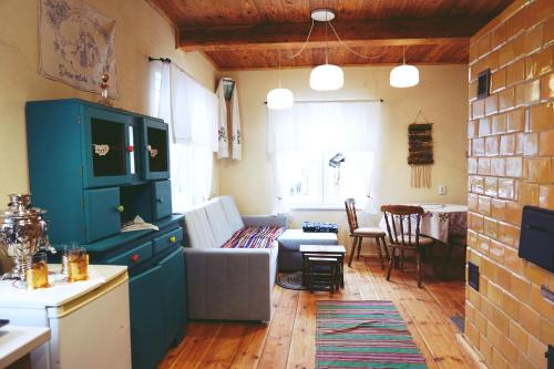 a kitchen and living room with a couch and a table at Agroturystyka Prynuka in Skroblaki
