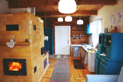 a kitchen with a brick wall with a fireplace at Agroturystyka Prynuka in Skroblaki